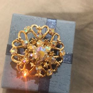 Vintage brooch in gold tone with aurora borealis stones
